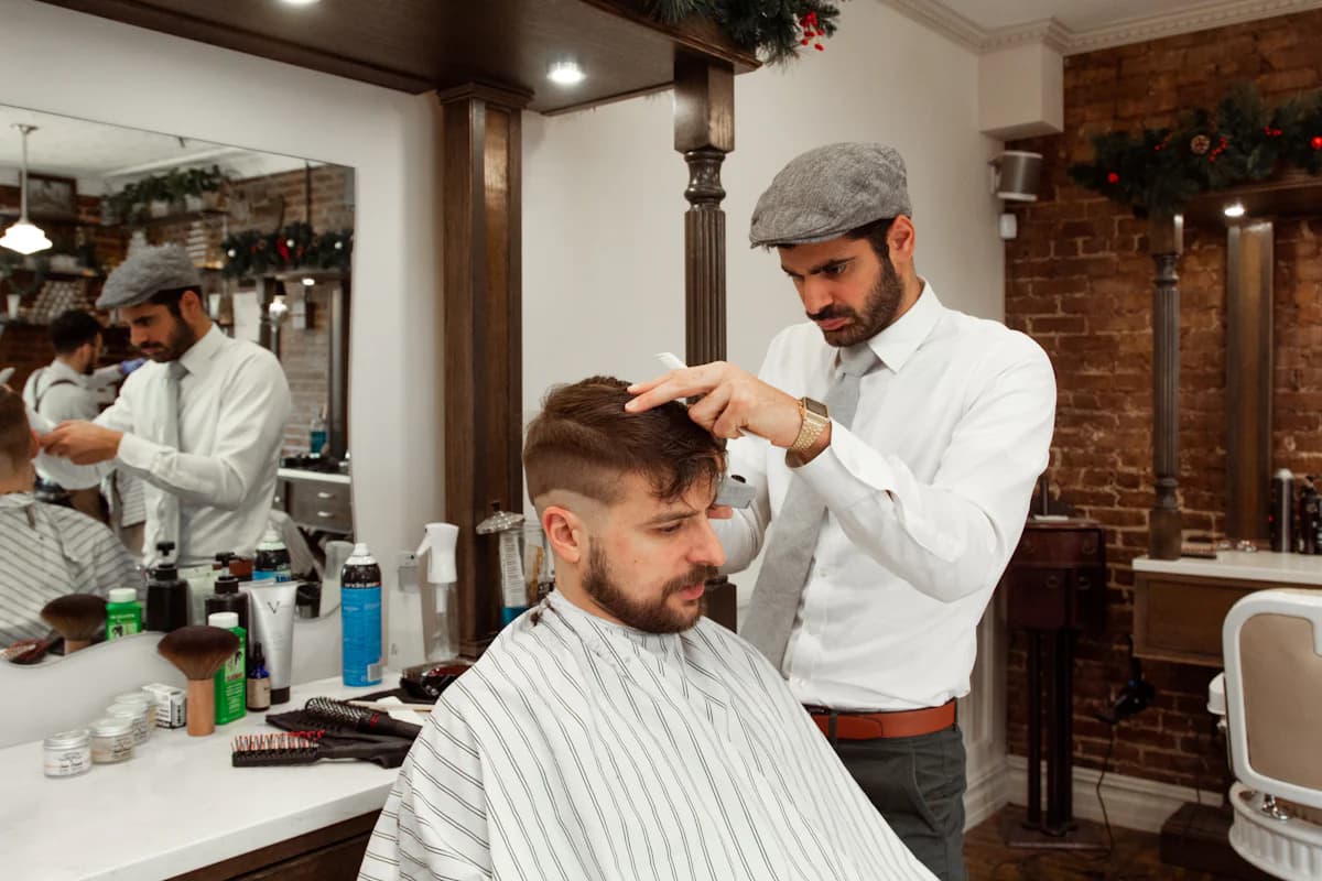 A barber mid-cut with a client in the chair